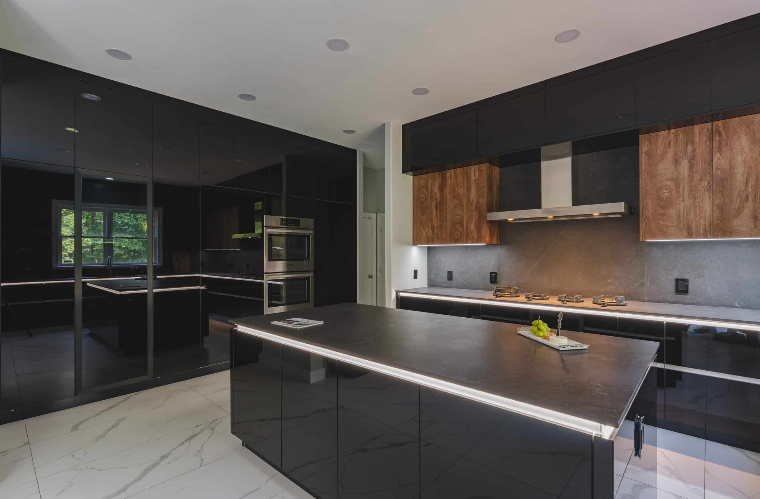A contemporary kitchen featuring sleek black and black countertops