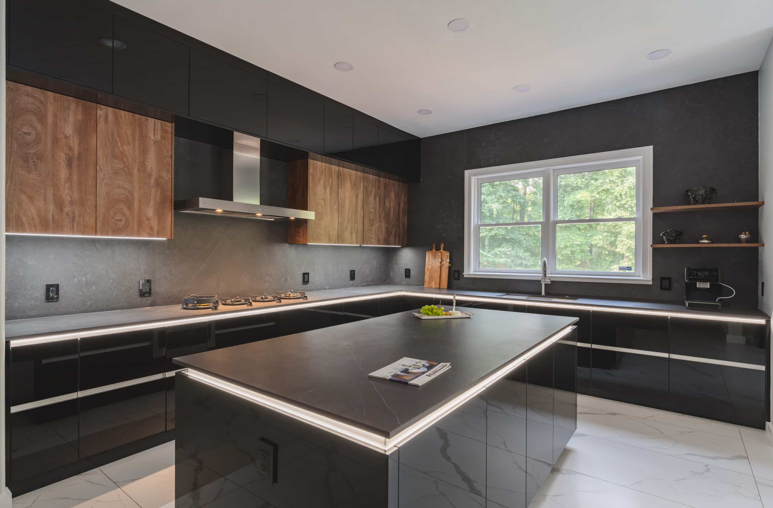 A contemporary kitchen featuring sleek black cabinets and countertop