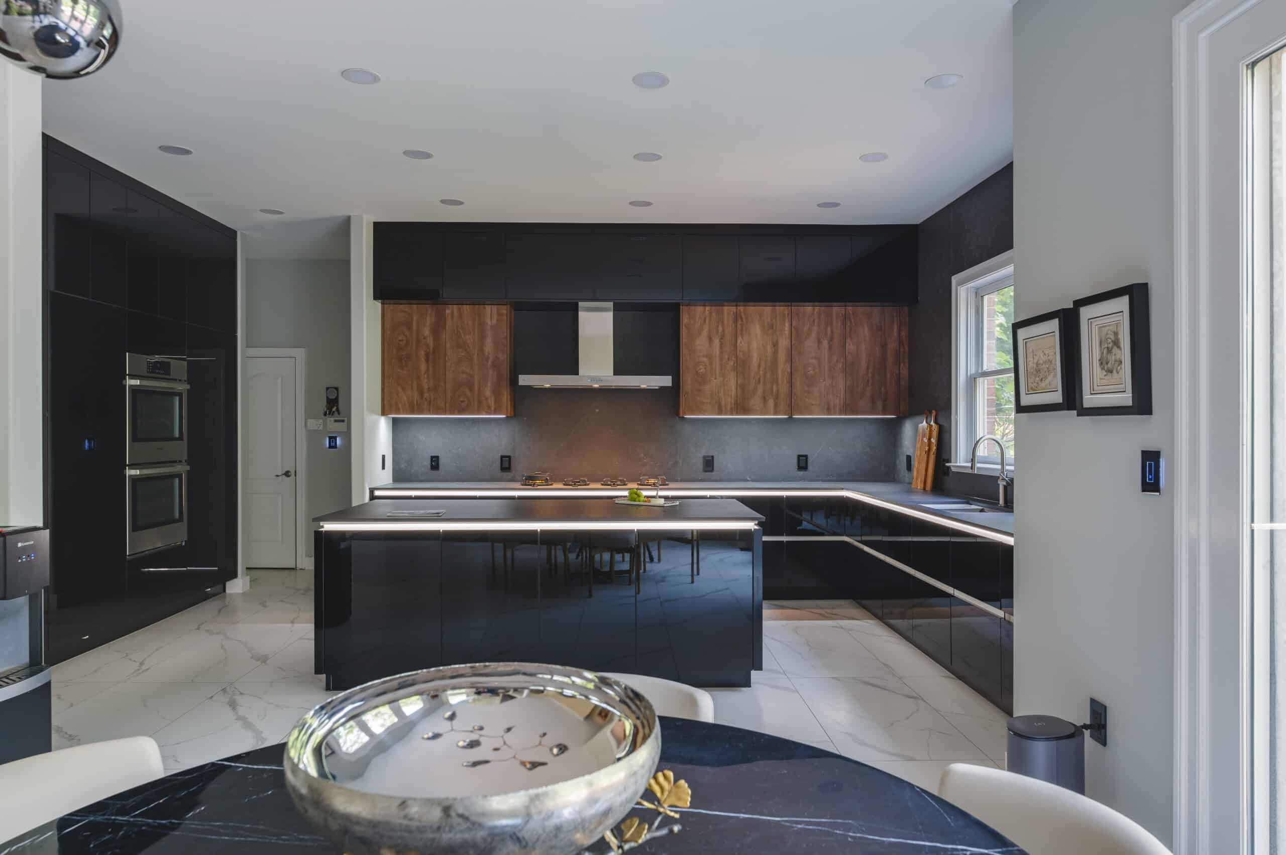 A contemporary kitchen featuring sleek black countertops and elegant wooden cabinet