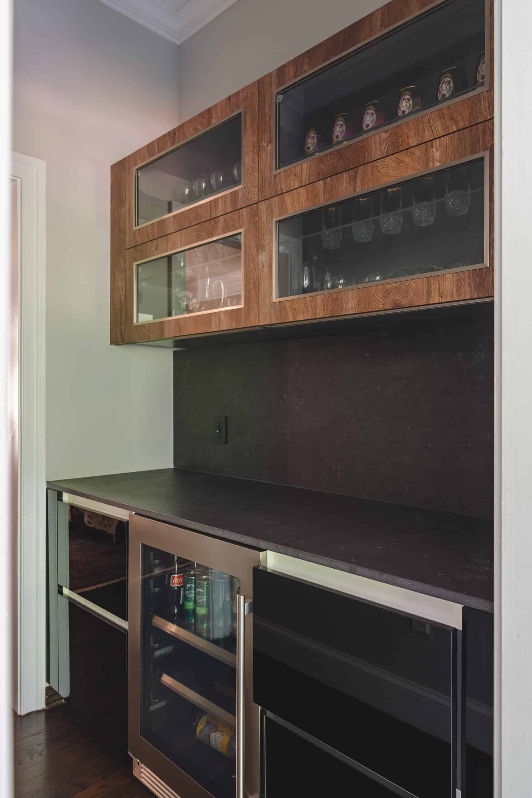 a kitchen with a wine rack and black countertops