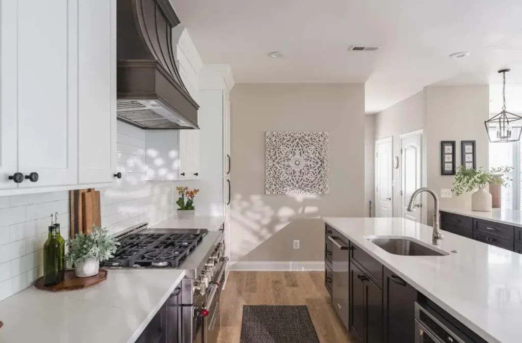 Park Creek Miyuki kitchen with professional gas range and custom dark wood vent hood