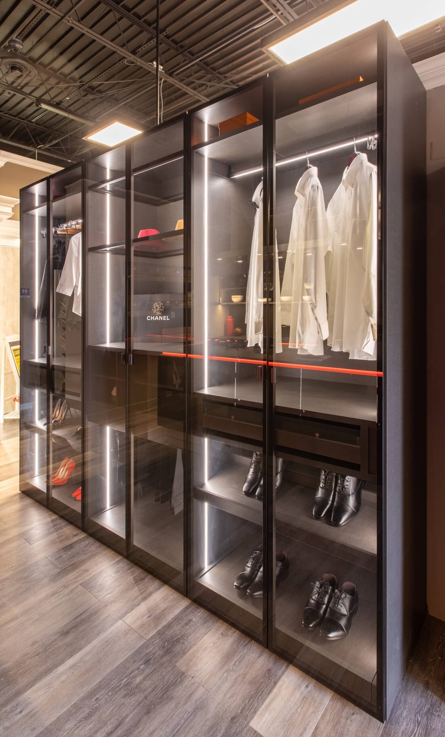 a walk in closet with a lot of clothes