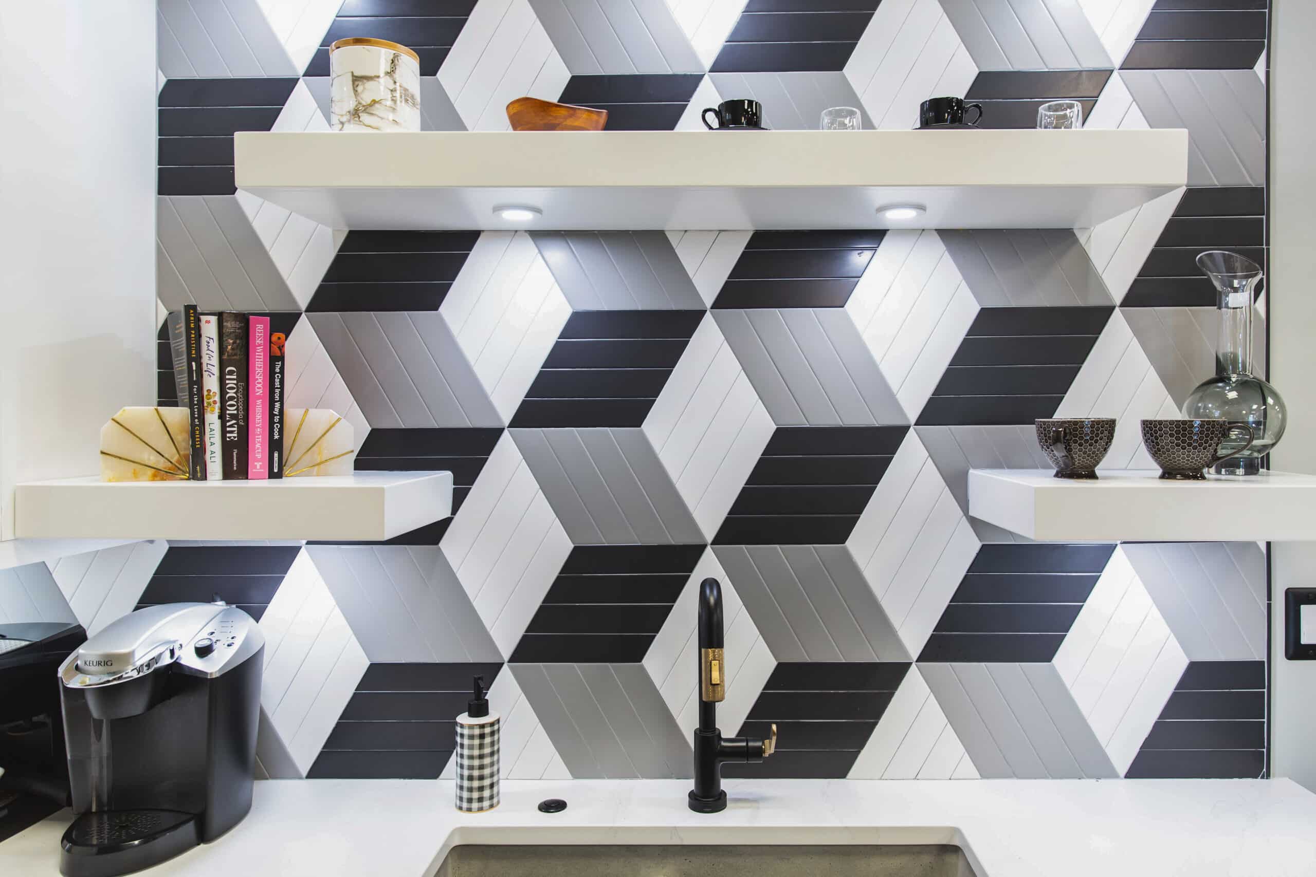 A kitchen with black and white geometric tiles, creating a stylish and modern design