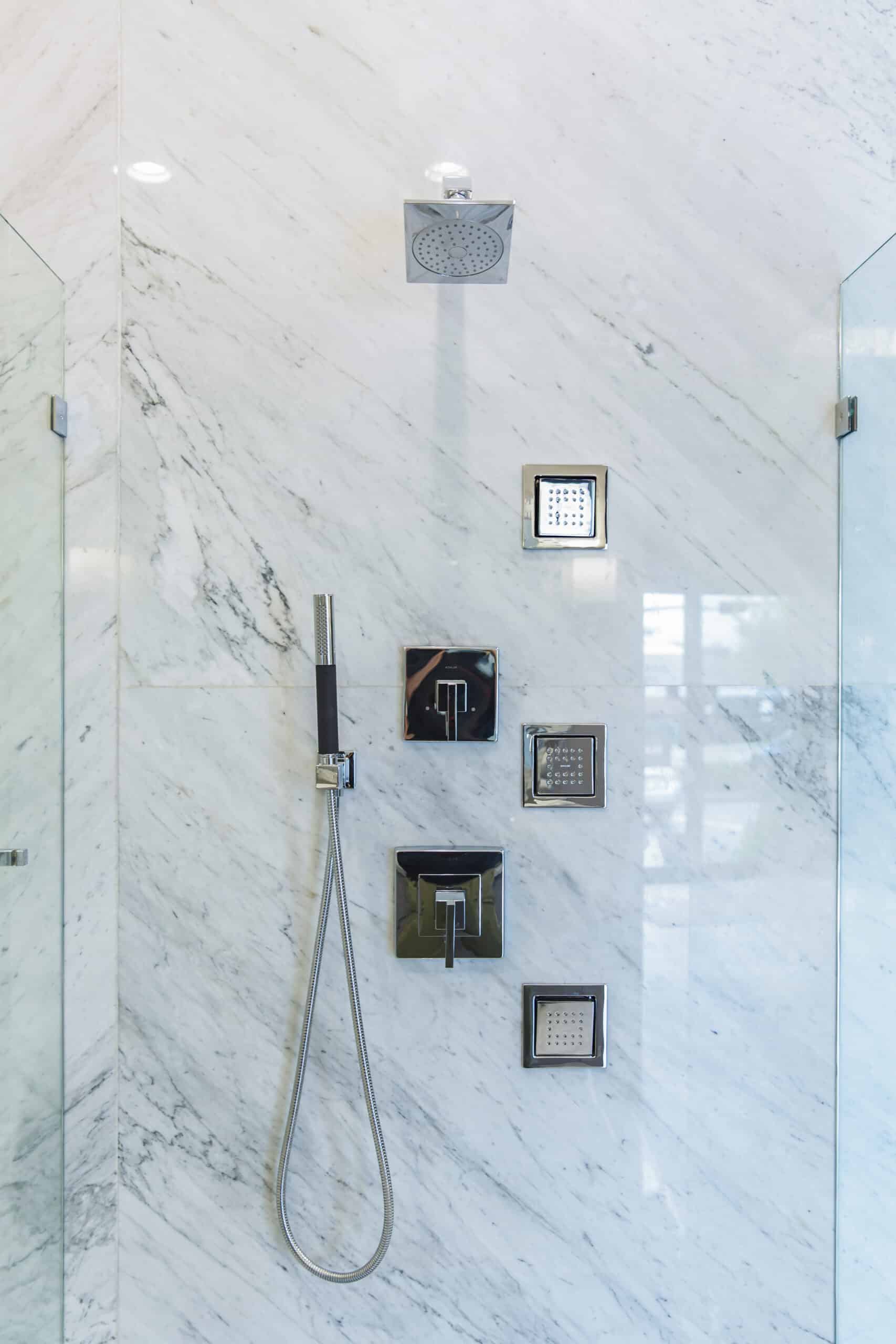 A sleek bathroom featuring a luxurious marble shower