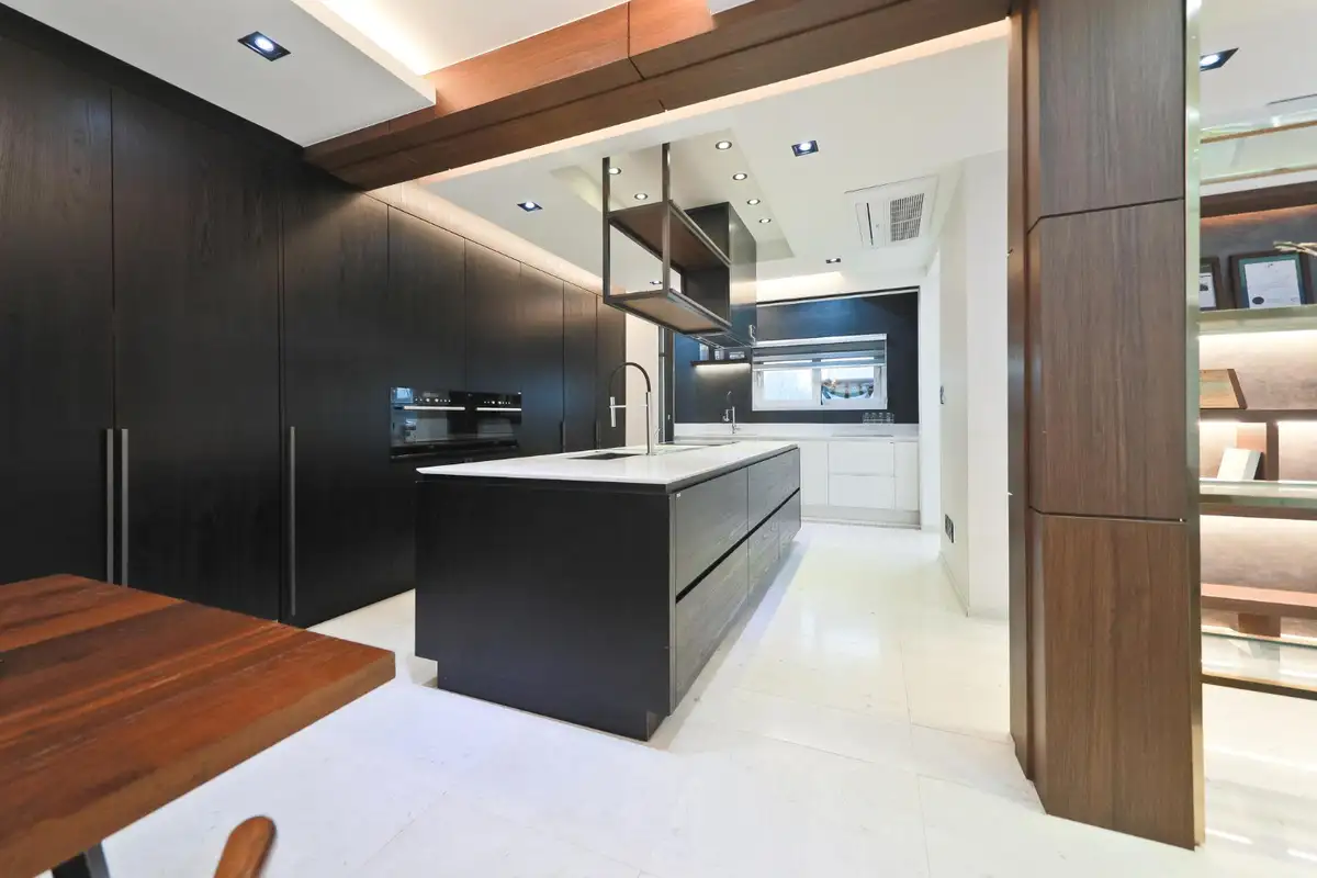 black cabinets are extended up to the ceiling of kitchen