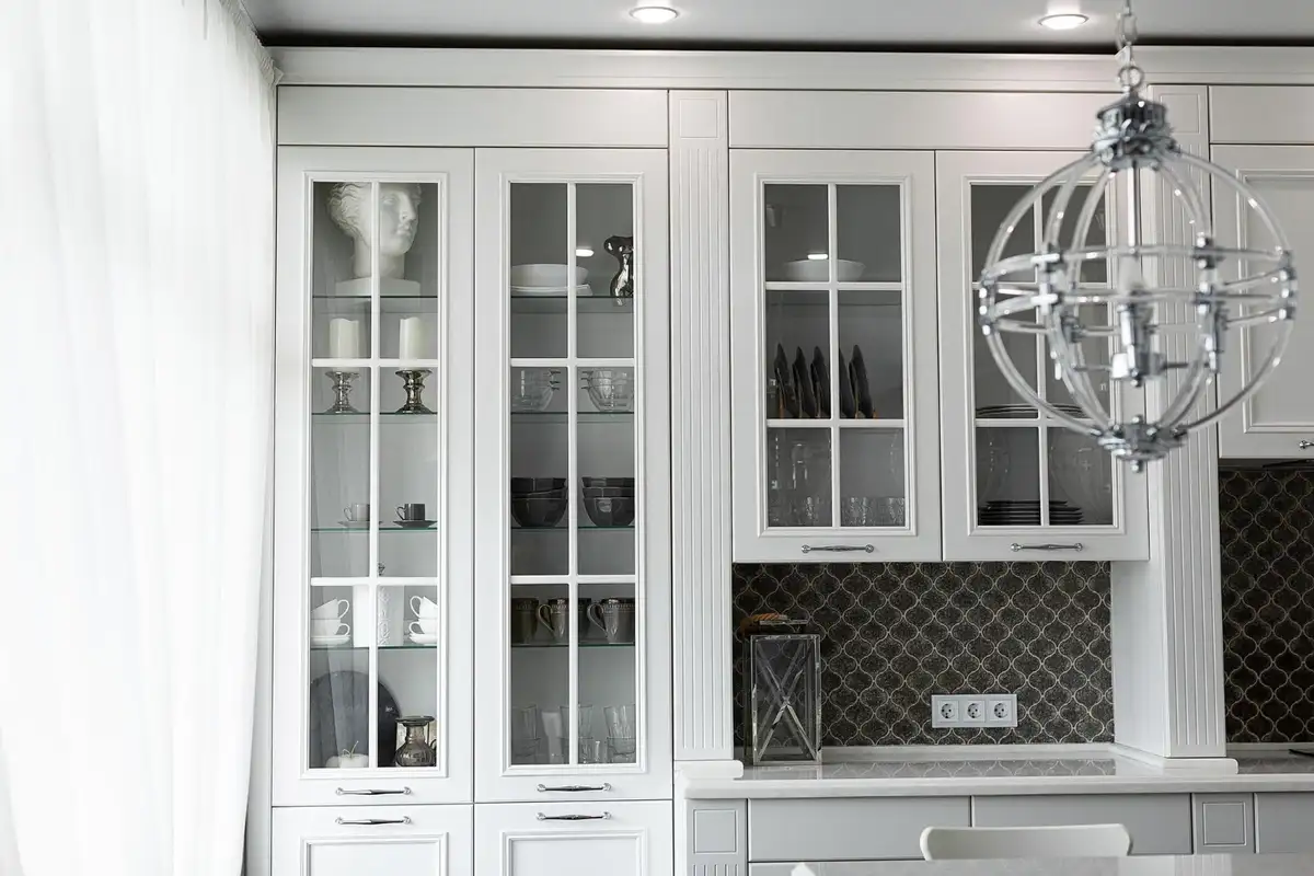 white kitchen cabinets with galasses