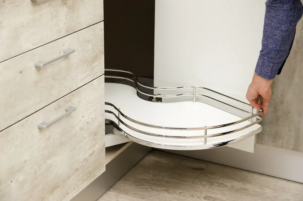 man pulls kitchen carousel out from bottom drawer