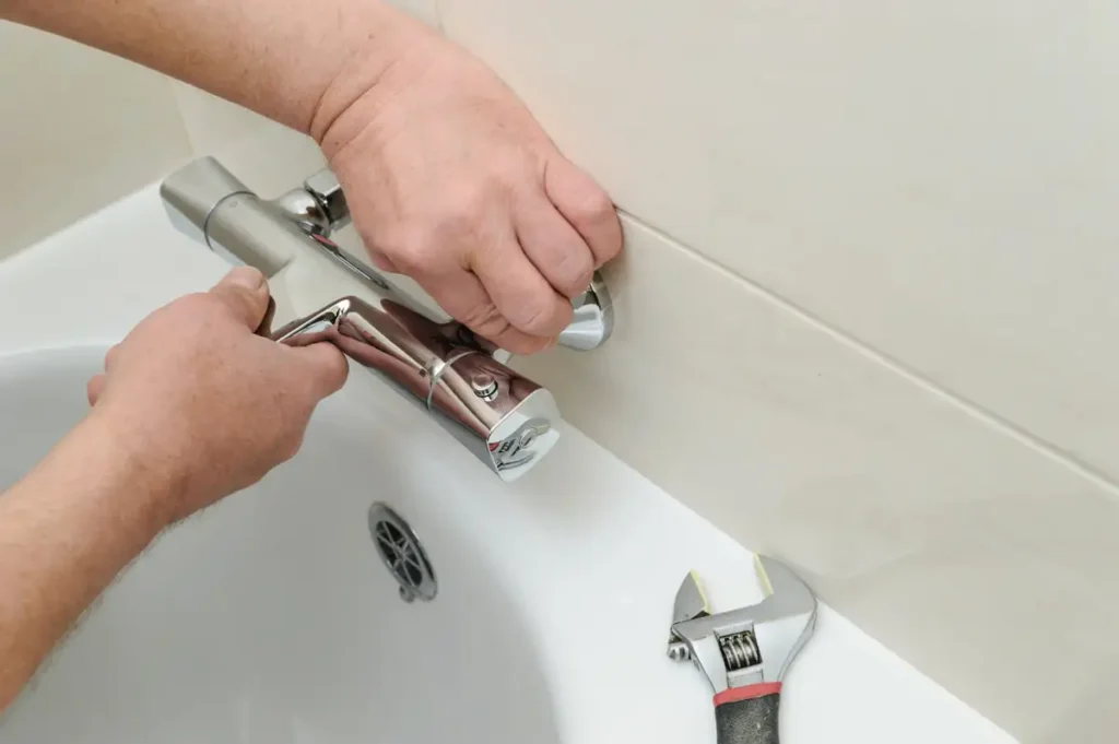 How to Replace a Bathtub Faucet: A Step-by-Step DIY Guide 1 Bathtub faucet man shows how to replace bathroom fuecet