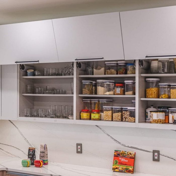 Fairfax kitchen renovation featuring modern white upper cabinets with lift-up doors and organized pantry storage containers.