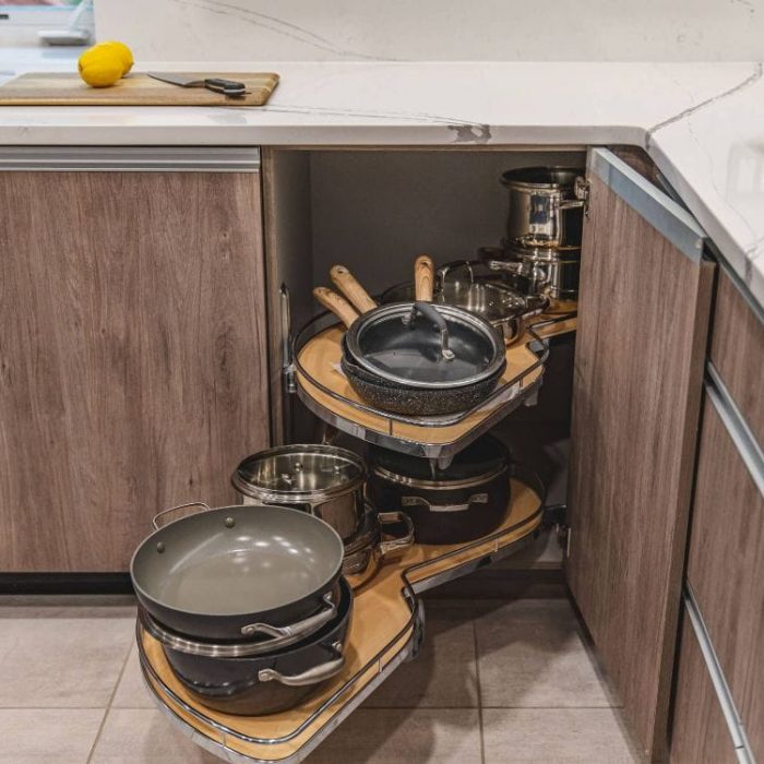 Fairfax kitchen renovation featuring a blind corner pull-out cabinet organizer for pots and pans with modern wood flat-panel doors.