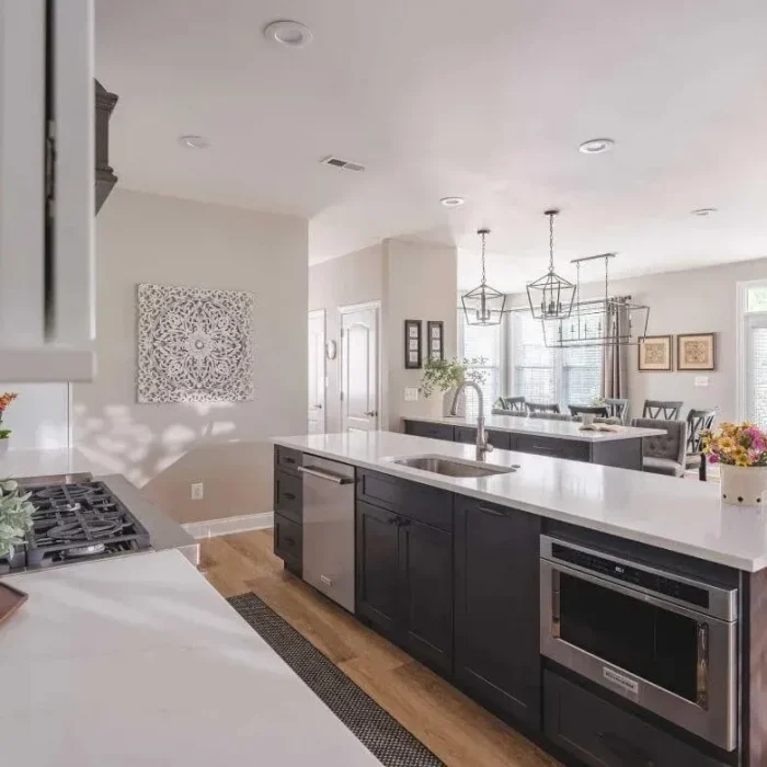 Park Creek Miyuki kitchen with dark wood island, integrated microwave, and white quartz countertops