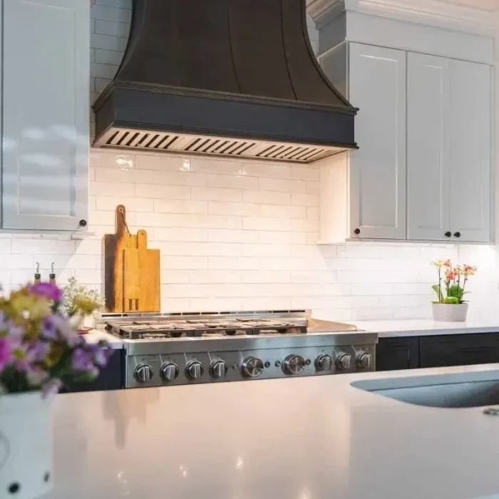 Park Creek Miyuki transitional kitchen with illuminated subway tile backsplash and custom range hood