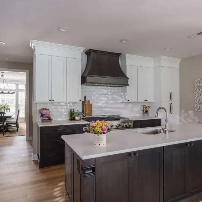 Park Creek Miyuki kitchen featuring a dark wood island, white shaker cabinets, and custom dark range hood