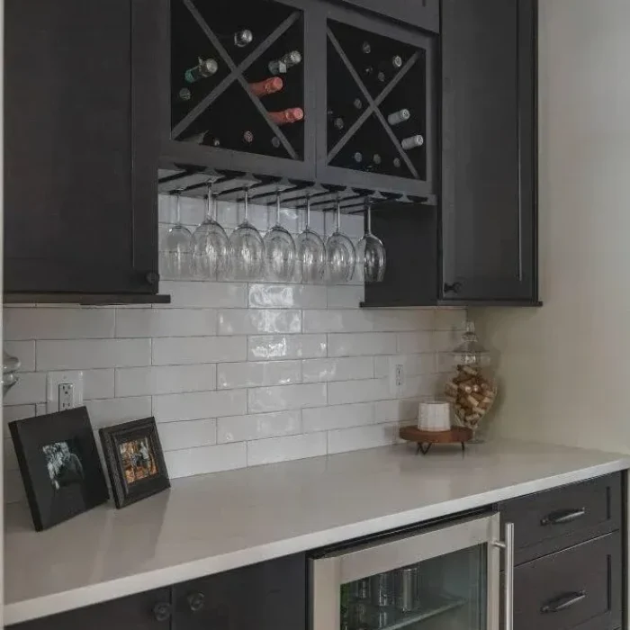 Park Creek Miyuki custom home bar with dark wood wine storage cabinets and beverage cooler